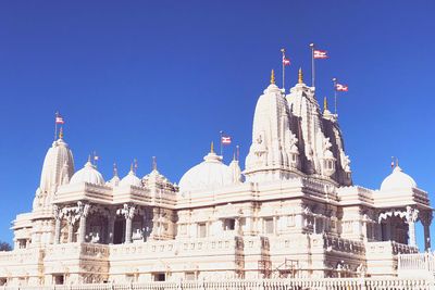 Low angle view of temple against clear blue sky