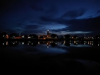 Illuminated city against sky at night