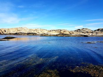 Scenic view of sea against blue sky