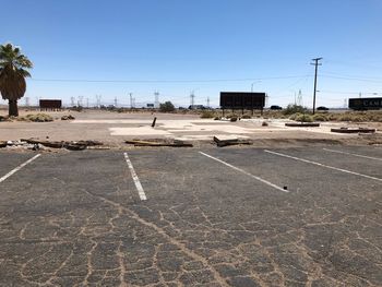 View of city street against clear blue sky