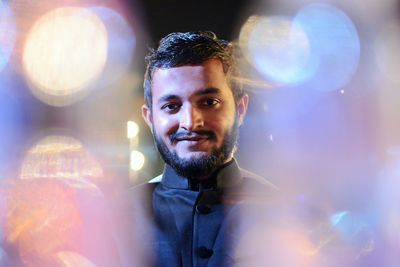 Portrait of smiling young man at night