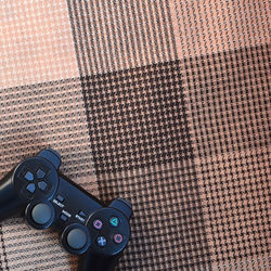 Directly above shot of game controller on textile