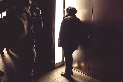 Rear view of people walking in corridor