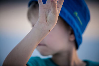 Close-up of bug on boy hand