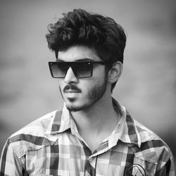 Portrait of young man against sky