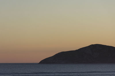 Scenic view of sea against orange sky