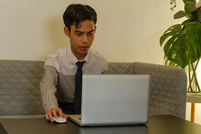 Young man using laptop at home