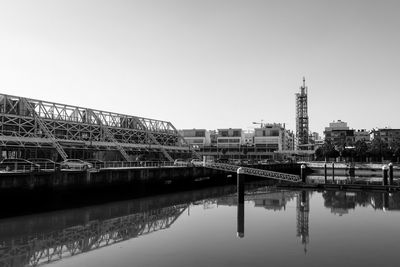 Bridge over city against clear sky