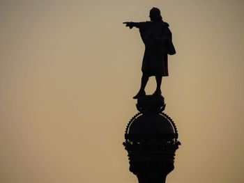 Low angle view of statue against sky during sunset