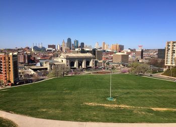 View of cityscape against clear blue sky