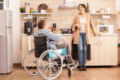 Woman sitting in front of two people at home