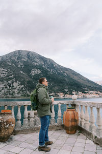 Rear view of man standing against mountain