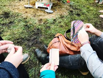 Low section of people sitting on land