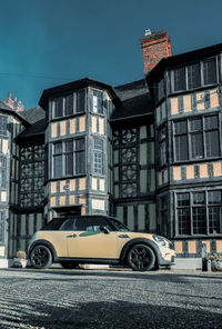 Car on street against buildings in city