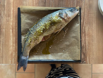 High angle view of fish on cutting board