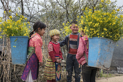 Rear view of people against plants