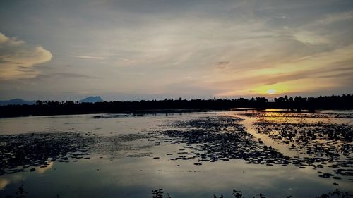 Scenic view of lake against sky during sunset