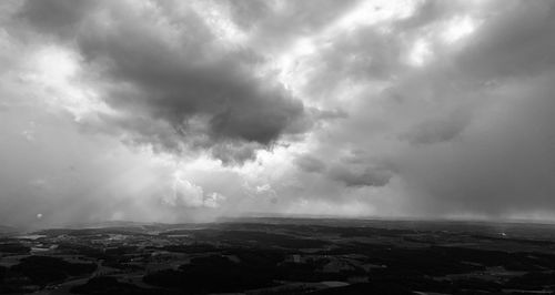 Scenic view of storm clouds over landscape