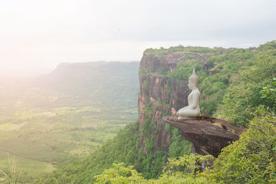 View of bird on mountain against sky