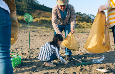 Family cleaning beach 