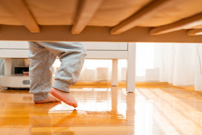 Low section of woman walking on floor