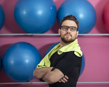 Portrait of young man with balloons in ball