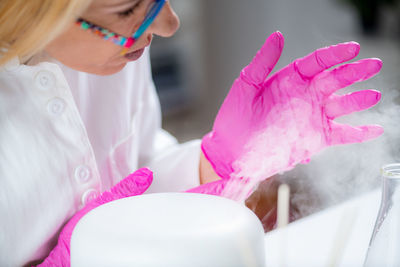 Aroma diffuser in a lab, olfactory science technician smelling the fragrance.