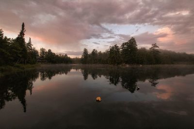 Scenic view of lake against sky at sunset