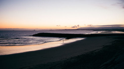 Scenic view of beach against clear sky