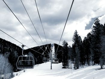 View of ski lift over snow covered landscape