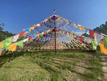 Low angle view of ferris wheel against clear sky