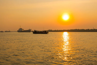 Scenic view of sea against orange sky