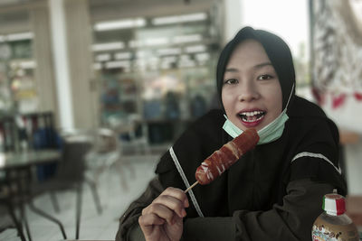 Portrait of woman holding ice cream