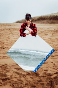 Full length of boy on beach against sky