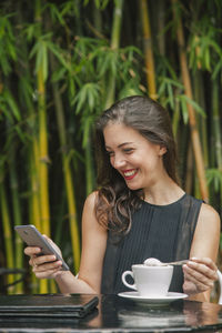 Young woman using smart phone outdoors