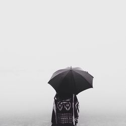 Woman standing against clear sky