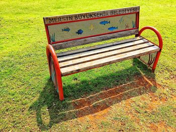 Empty park bench on grassy field