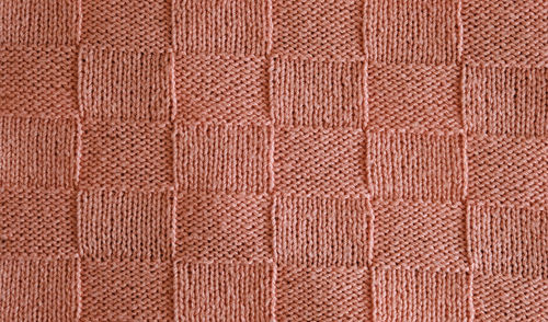 Unusual abstract knitted chess pattern background texture. handmade knitting wool