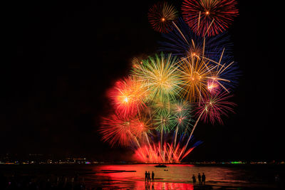 Low angle view of firework display at night