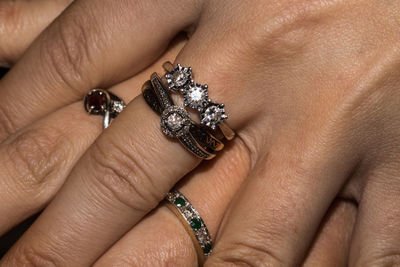 Cropped image of woman hands showing rings
