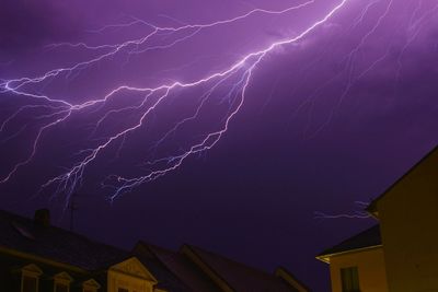 Low angle view of illuminated building against sky