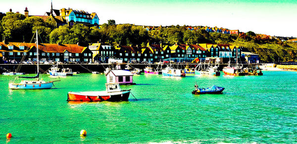 Boats moored in sea against sky