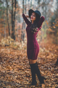 Full length of woman standing in forest during autumn