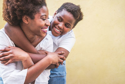 Happy woman with baby girl standing at home