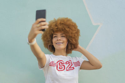 Woman with afro hair taking a selfie