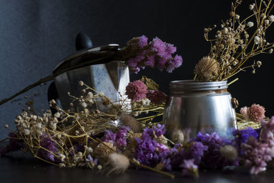 Close-up of purple flower in glass vase on table