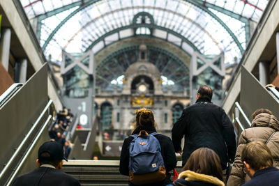 Rear view of people walking at railroad station