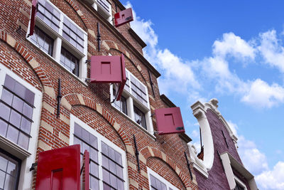 Low angle view of statue against buildings in city