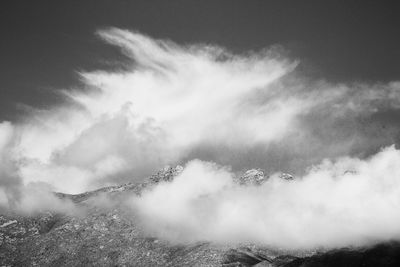 Scenic view of mountains against sky in foggy weather