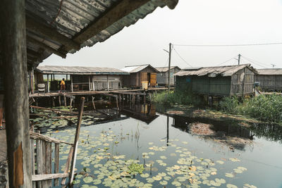 Reflection of buildings on lake against sky